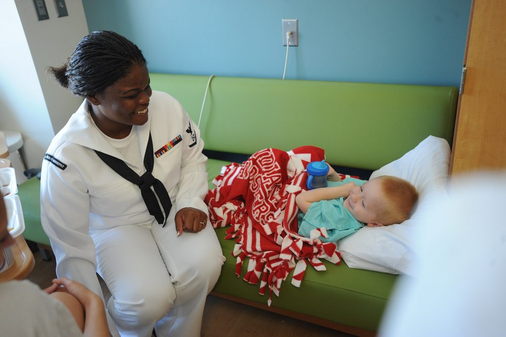 A US Navy sailor visits a patient at the Roudebush VA Medical Center, Indianapolis.